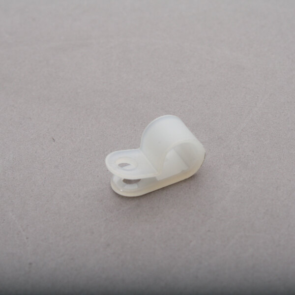 A white plastic Cres Cor nylon clamp on a grey surface.