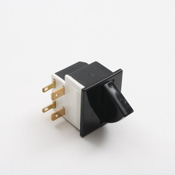 A close up of a black and white switch with gold metal pins.