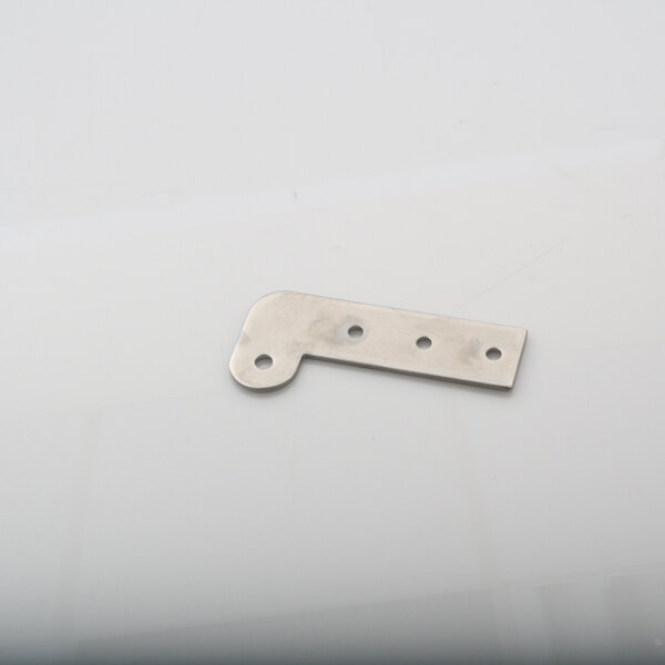 A metal hinge plate with holes on a white surface.