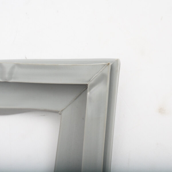 A close up of a grey plastic Victory 50601506 Gasket frame.
