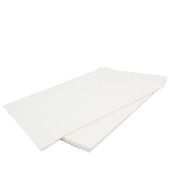 A stack of Keating filter paper on a white surface.