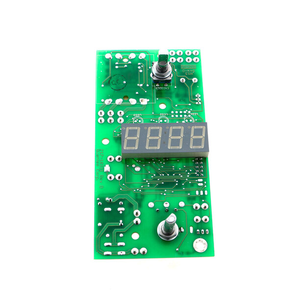 A green circuit board with a digital display.