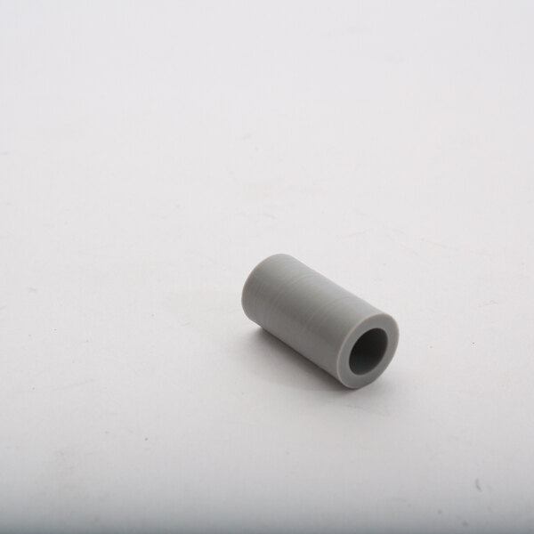 A grey cylindrical Champion spacer with a hole in it.