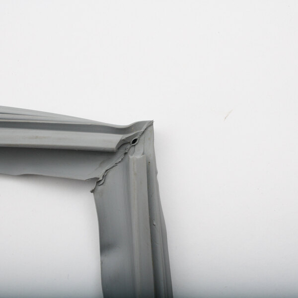 A corner of a grey Silver King refrigerator door gasket.