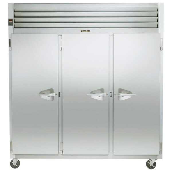 A Traulsen G Series reach-in freezer with three white doors.