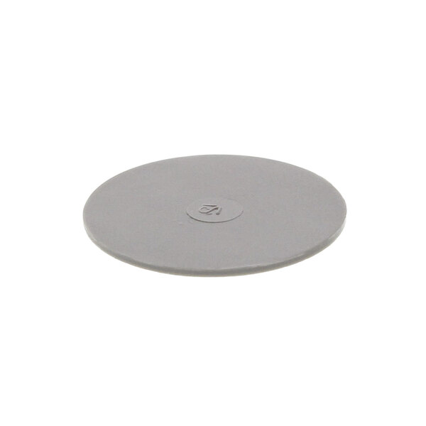 A gray circular plastic cover with a circular hole.
