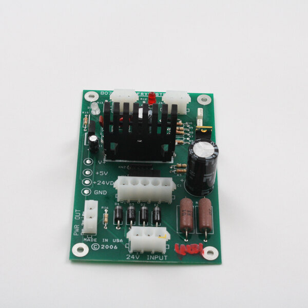 A green Frymaster Intfc(Dc)Sinbad Jr. circuit board with black and white components.