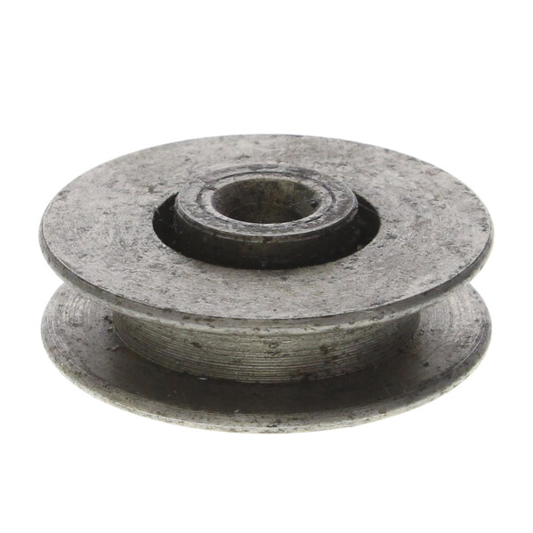 A close-up of a round metal object with a hole in it.