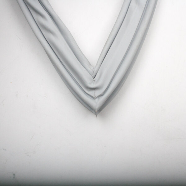A grey fabric Delfield gasket hanging on a wall.