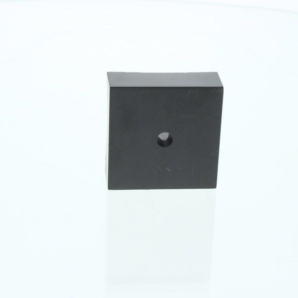 A black square Cornelius timer delay with a hole in it on a white background with a black border.