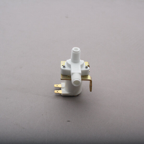 A white plastic Scotsman inlet valve with a metal bracket.
