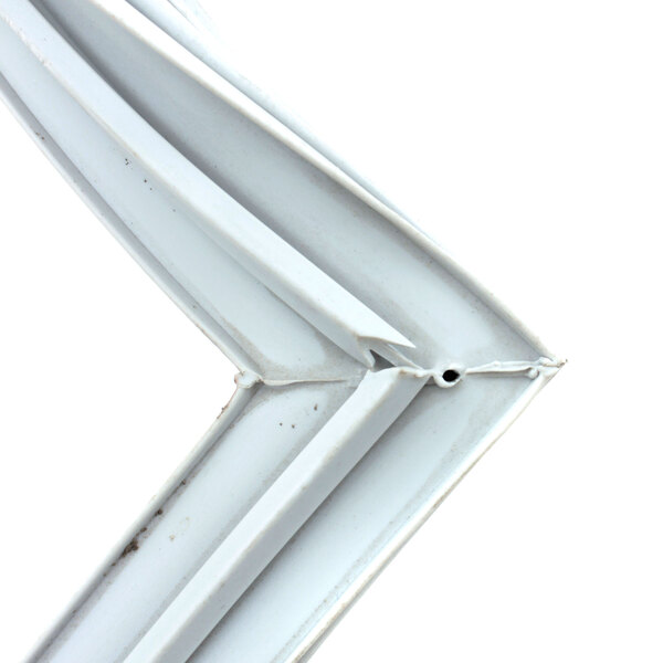 A close-up of a corner of a white plastic object with a white metal frame.
