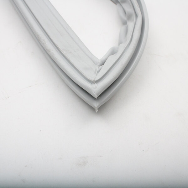 A close-up of a white plastic Delfield refrigerator door gasket.