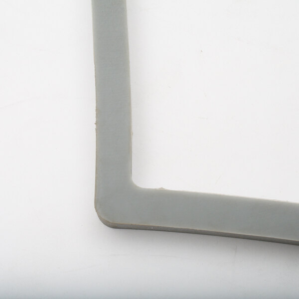 A grey plastic corner of a Henny Penny lid gasket.