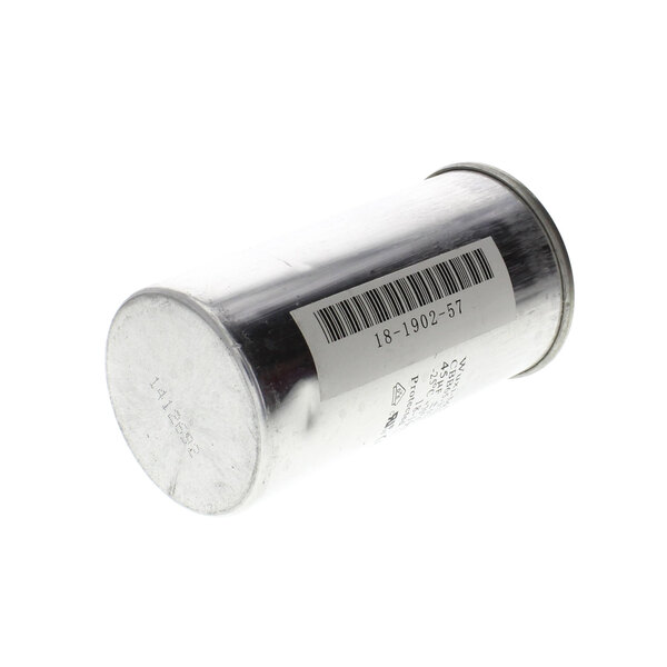 A silver metal Scotsman run capacitor cylinder with a barcode.