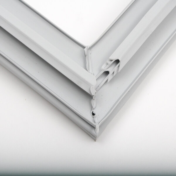 A close-up of a white metal frame with a corner of a gasket.