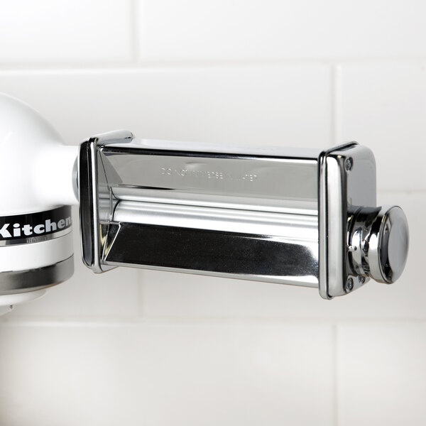 A KitchenAid pasta roller attachment on a counter.