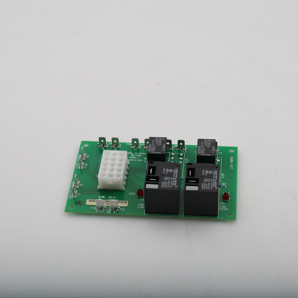 A green circuit board with black and white components, including two small switches.