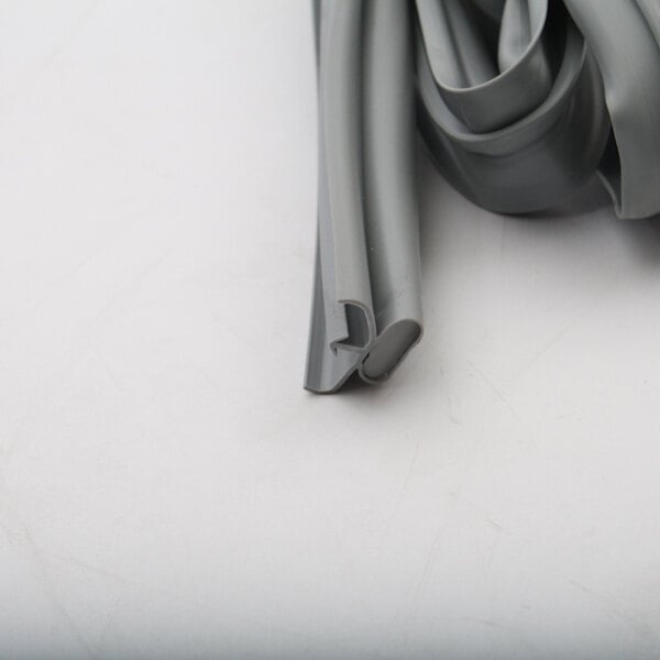 A roll of grey rubber tubing on a white surface.