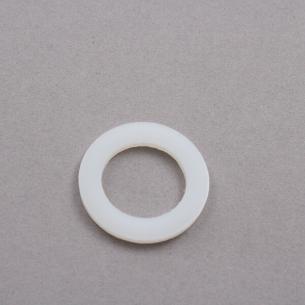 A circular white spacer with a hole in it.