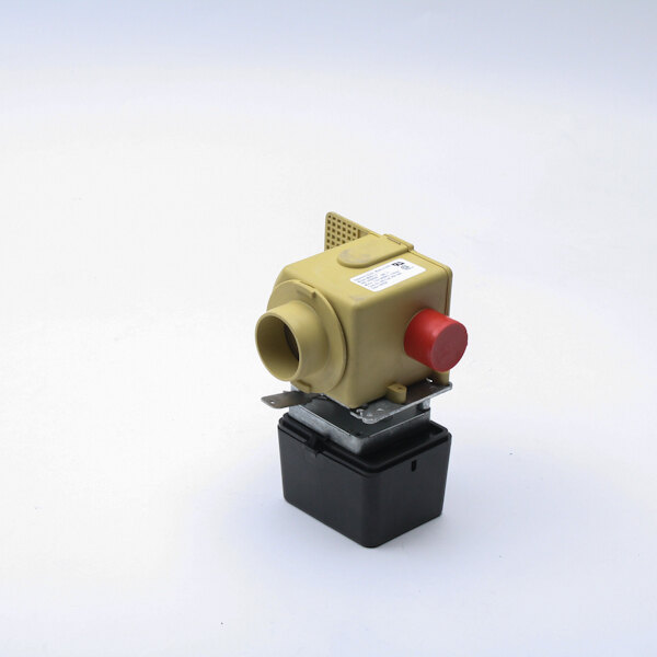 A white rectangular object with a small yellow and red valve on it.