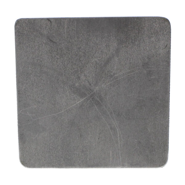 A painted grey square metal plate with a hole in it.