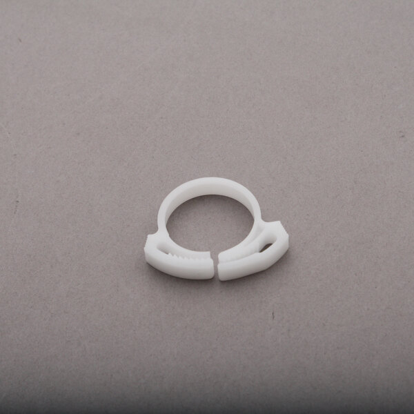 A white plastic Ice-O-Matic hose clamp ring.