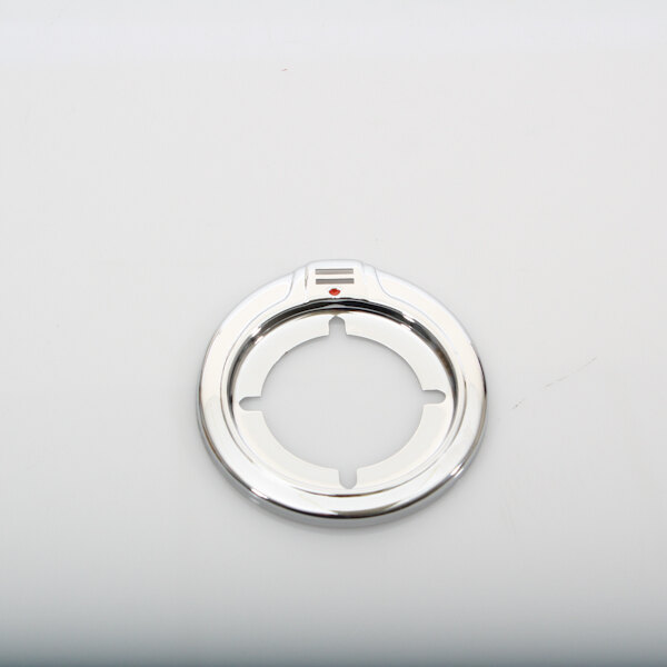 A round silver metal BKI thermostat bezel with a red dot.
