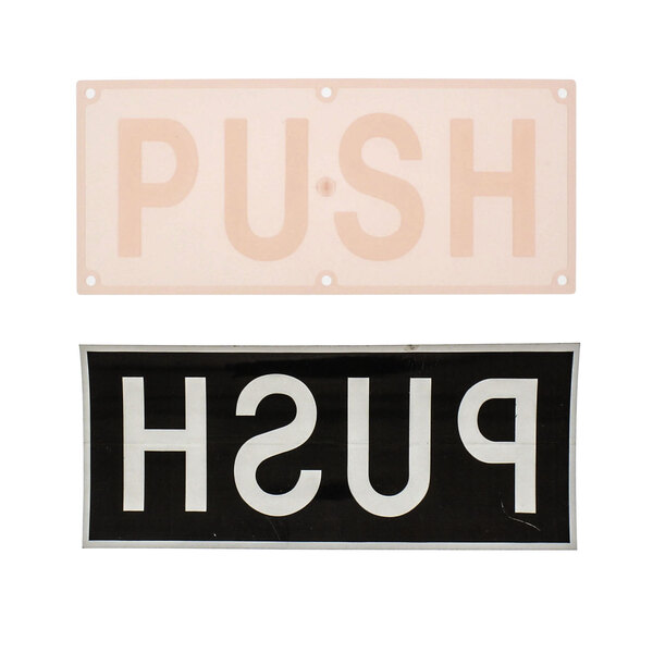 A close-up of a white sign with black letters that says "PUSH" and "PULL"
