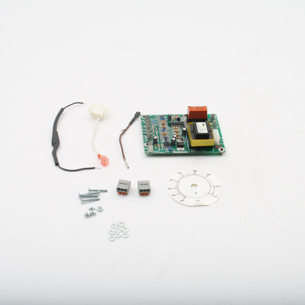 A white circular circuit board with wires and screws.
