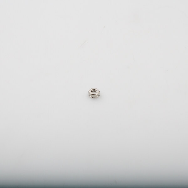 A Vulcan NS-046-88 nut, a small silver object on a white surface.