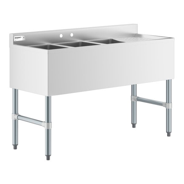 A stainless steel three-compartment sink with a right-side drainboard and four sturdy legs.