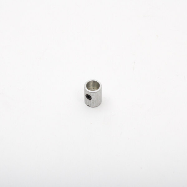 A metal cylinder with a hole on a white surface.