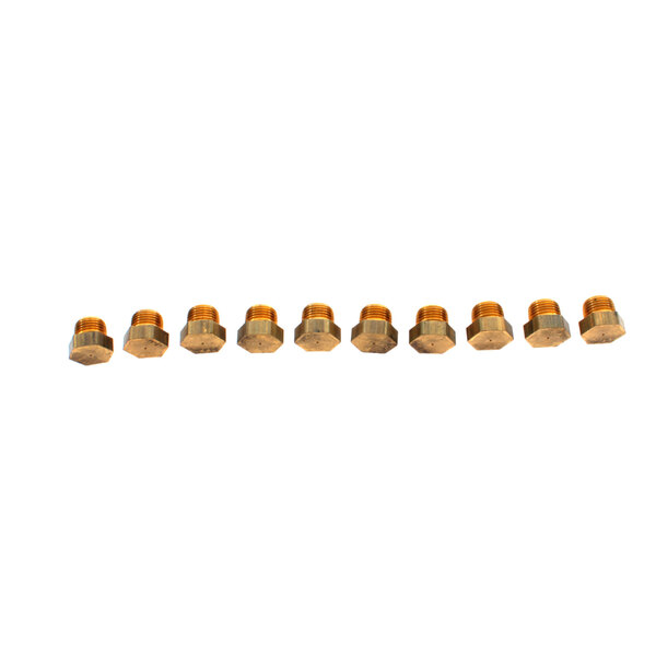 A row of brass Frymaster burner orifices.