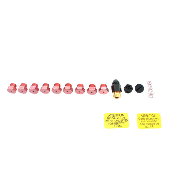 A row of red and black plastic Frymaster conversion parts.