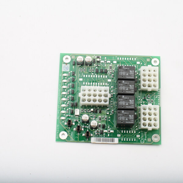 A green circuit board with many small white and black objects.