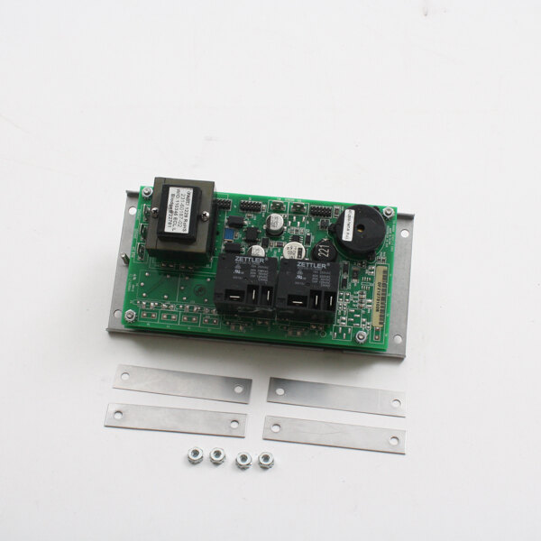 A green Blodgett controller dig circuit board with black and white electronic components and screws.