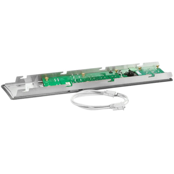 A green and white electronic circuit board with cables attached.