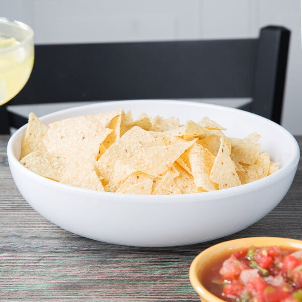 A Diamond White melamine bowl of chips and salsa on a table.