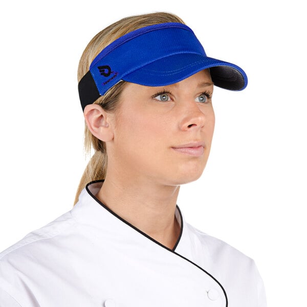 A woman wearing a royal blue Headsweats visor.