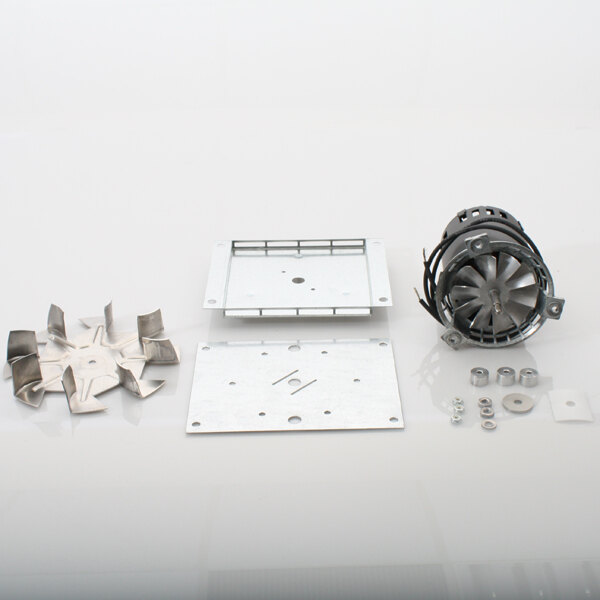 A group of metal parts on a white surface with holes and a square in the middle, including a Winston Industries Inc. circulating fan motor.