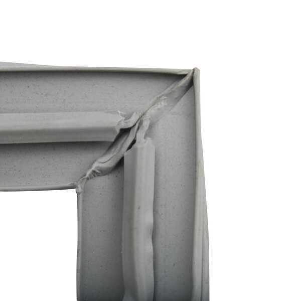 A close-up of a broken corner of a gray plastic Kairak gasket.