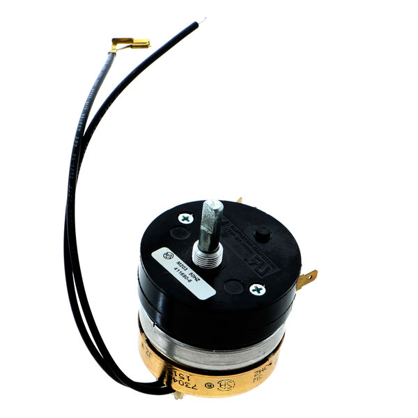 A small black and gold electric motor with wires attached to it.