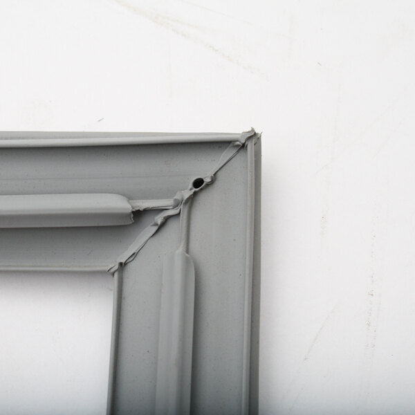 A close up of a gray metal Kairak gasket frame.