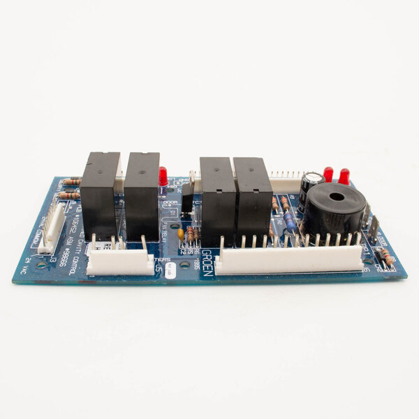 A Groen Z098666 control board with three electronic components, black and red buttons, and a blue circuit board.