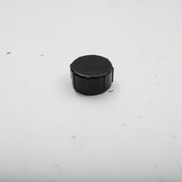 A black plastic cap with black text on a white surface.