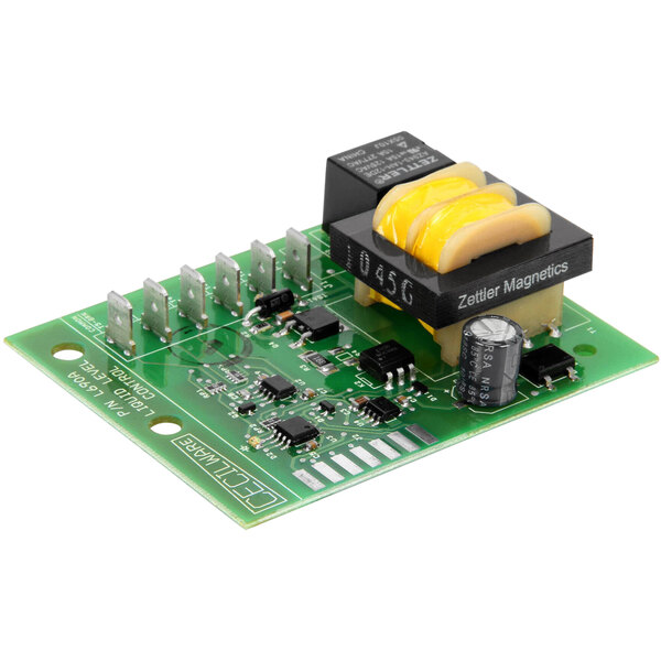 A green circuit board with a yellow and black object, a capacitor, and a device.