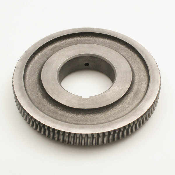 A circular metal Groen gear with a hole in it.
