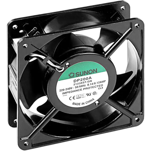 A black fan with a white label and green and black wires.
