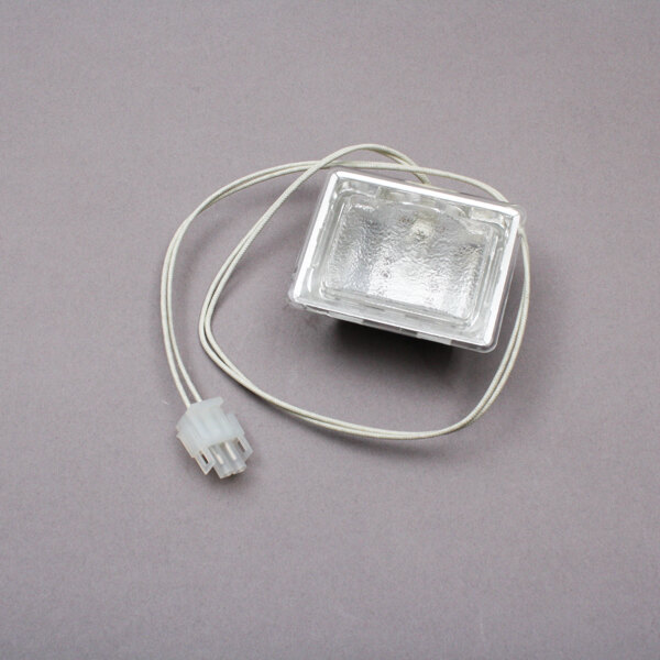 A BKI LH0024 lamp holder in a clear plastic box with a wire.
